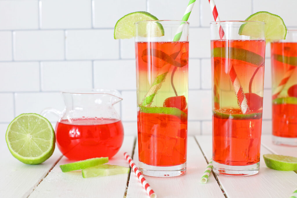 vodka cherry limeade cocktail in a tall glass with a straw