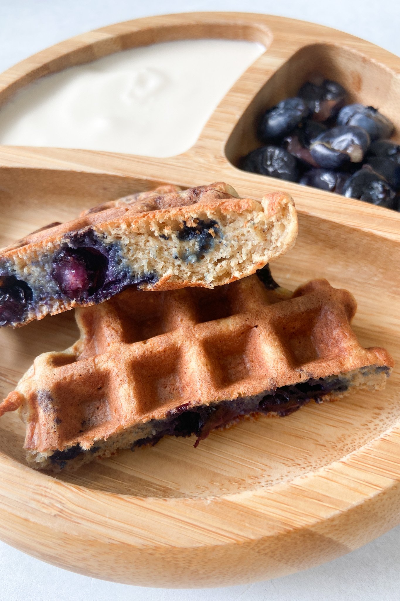 Blueberry banana waffles served with yogurt and a side of blueberries