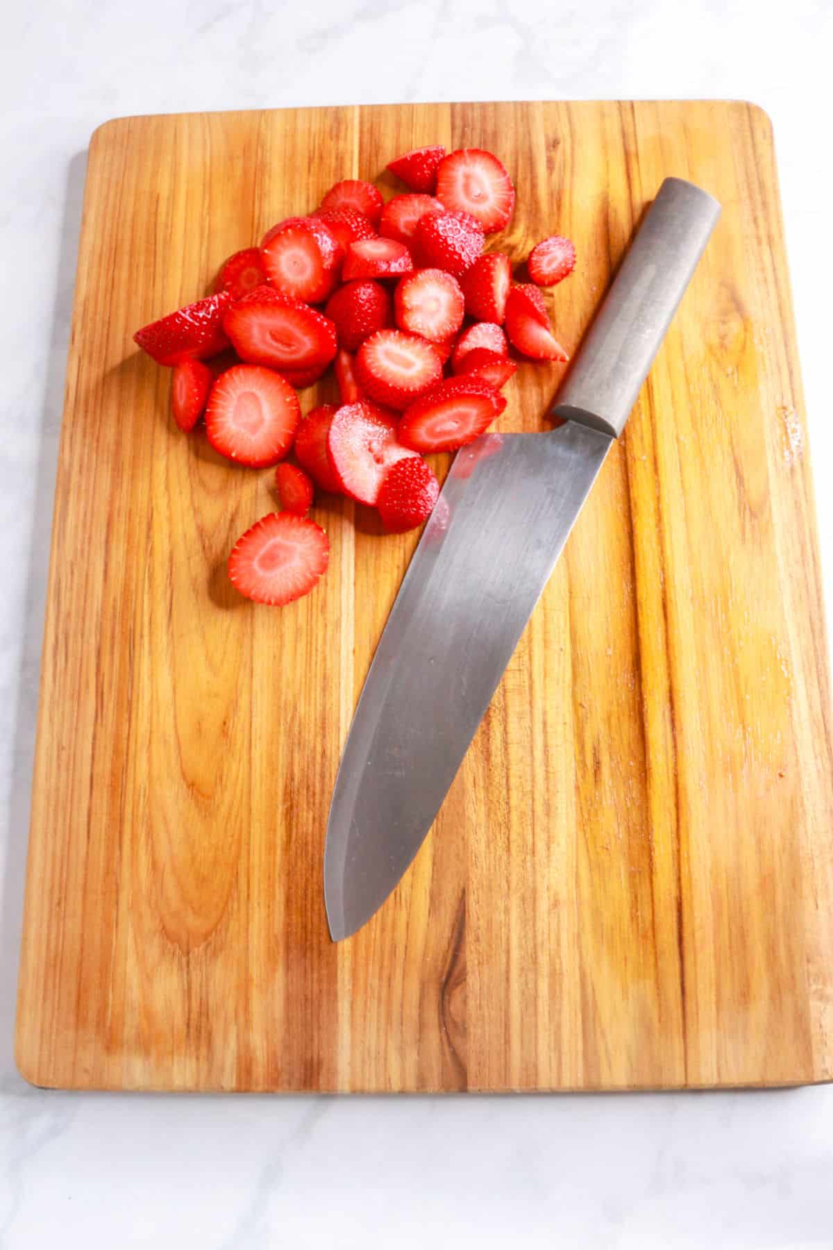 Chopped strawberries on a cutting board