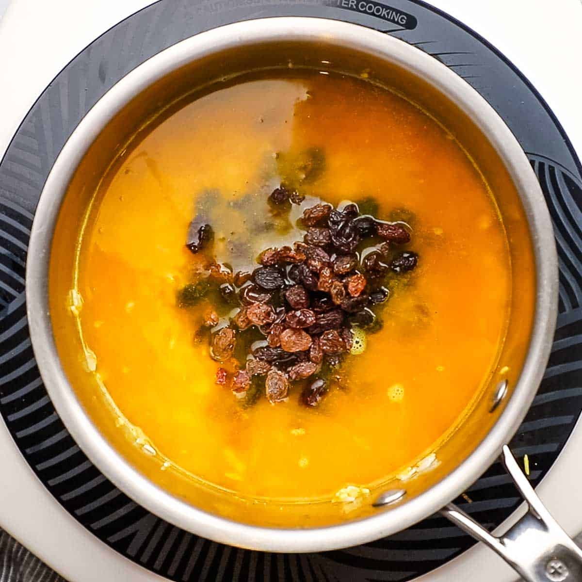 broth and raisins added to the pot