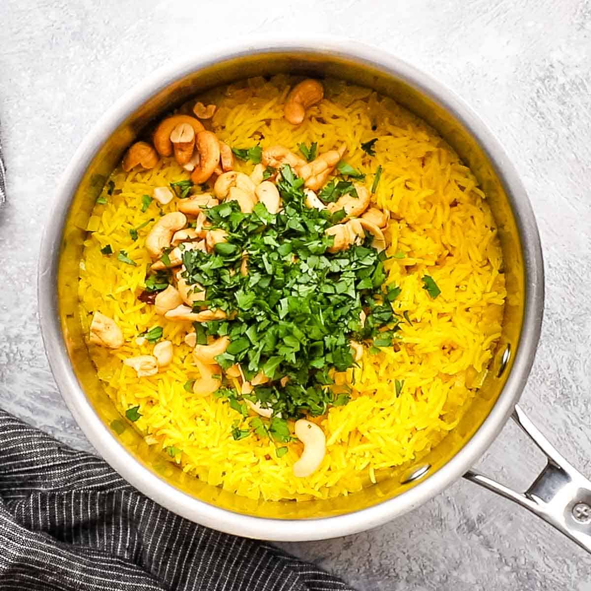 cashews and cilantro added to the rice pot