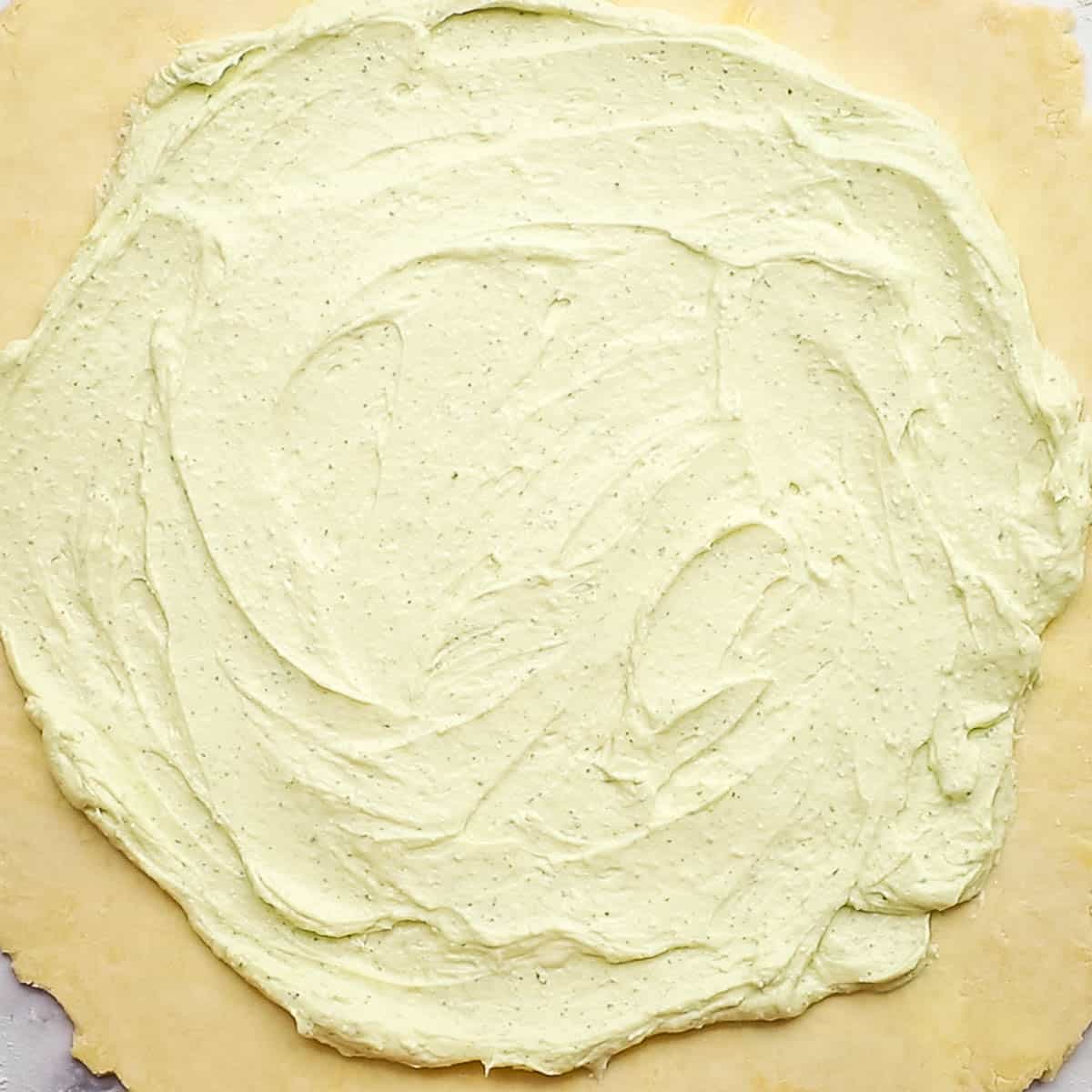 whipped feta spread out on the dough