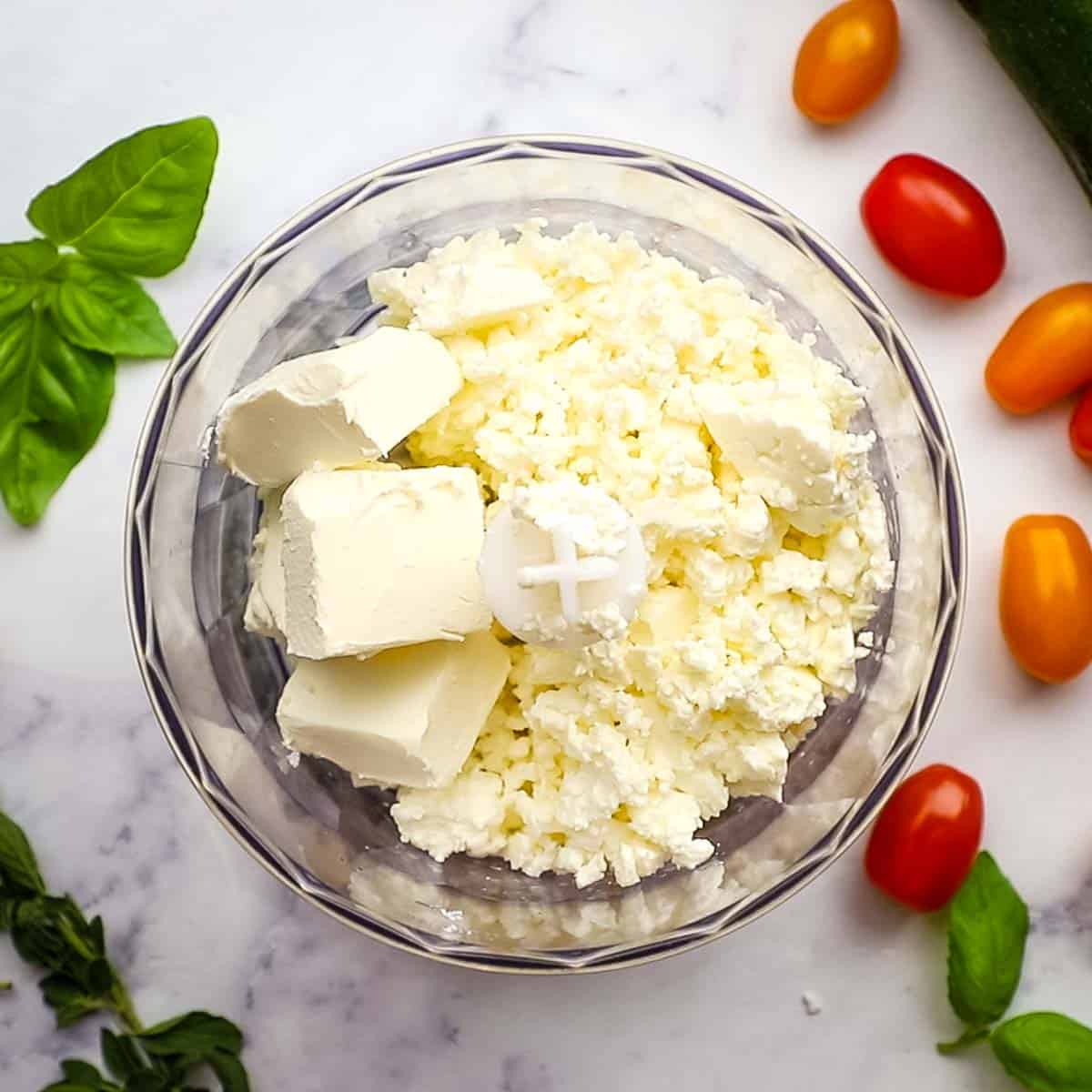 pulsing together the feta and cream cheese in a food processor