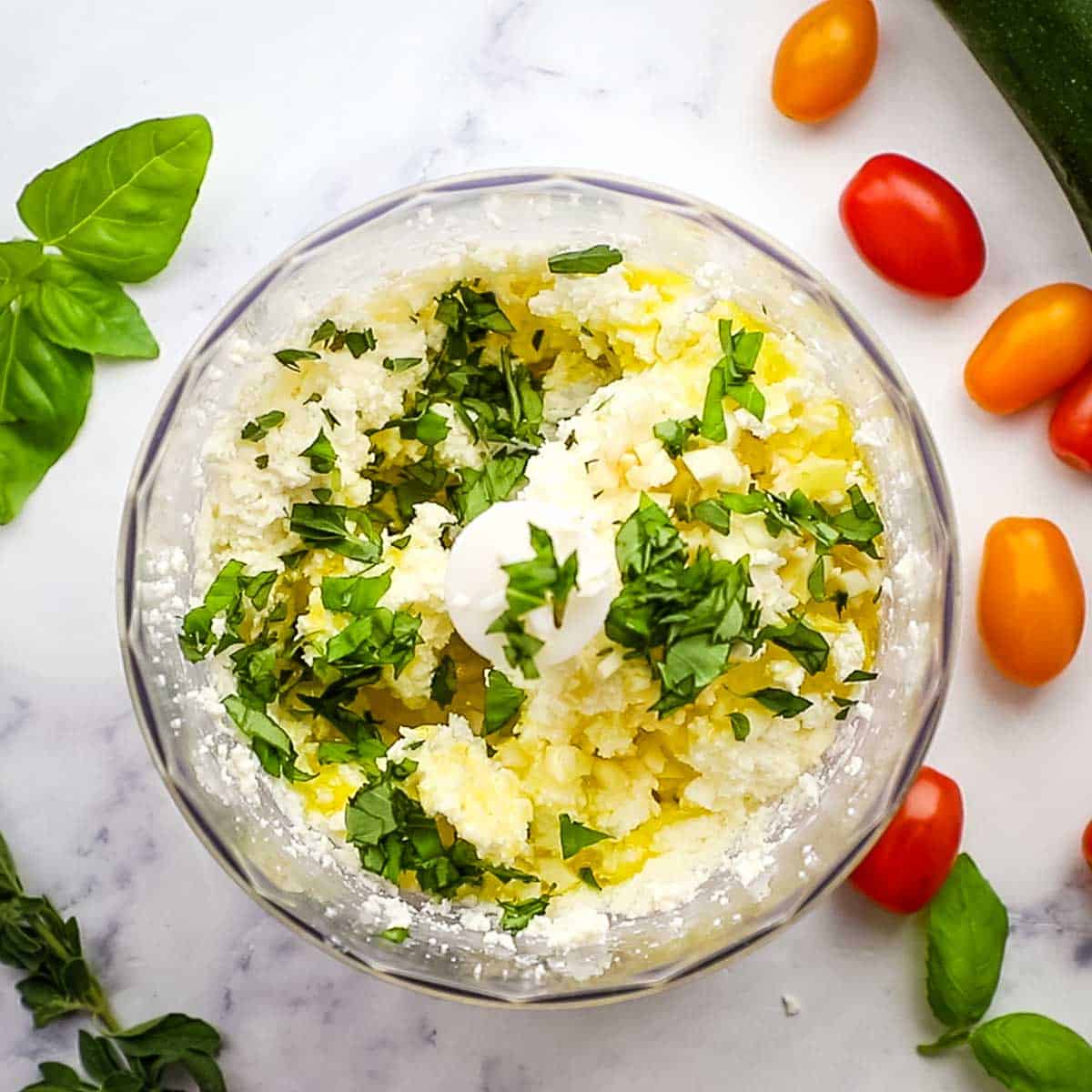 herbs and olive oil added to the feta and cream cheese mixture