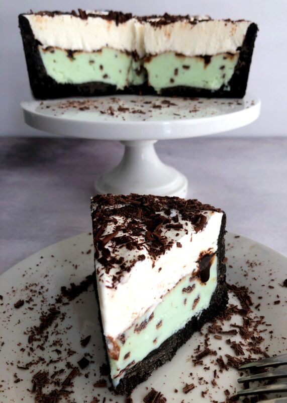 a slice of mint ice cream pie with an oreo crust and the pie on a pie plate behind