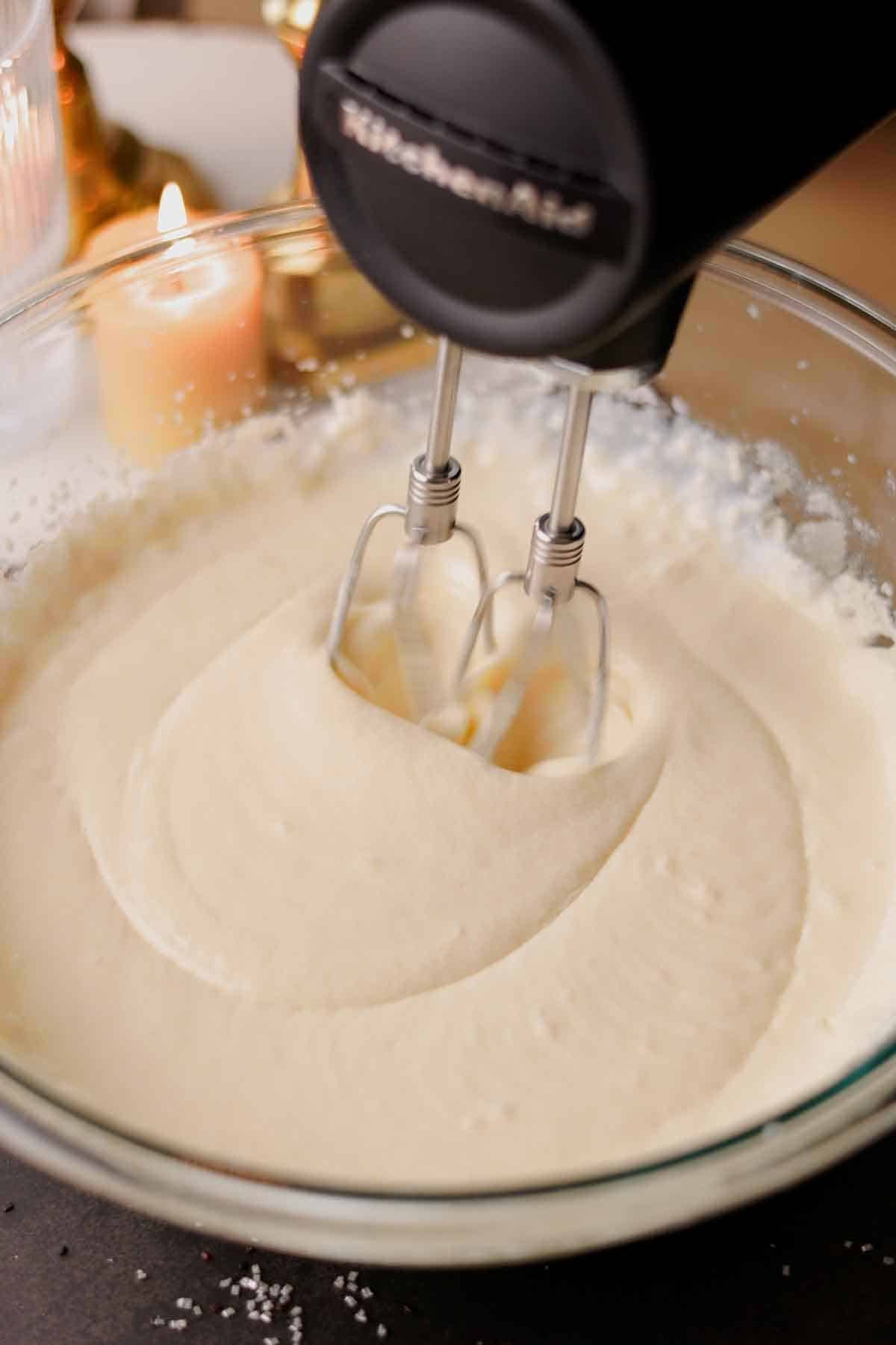beating smooth and runny liquid ingredients with an electric mixer