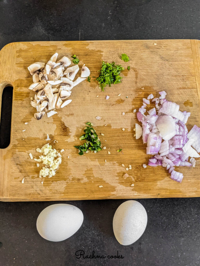 chopped mushrooms, onion, chilli, cilantro and garlic with 2 eggs for making omelet