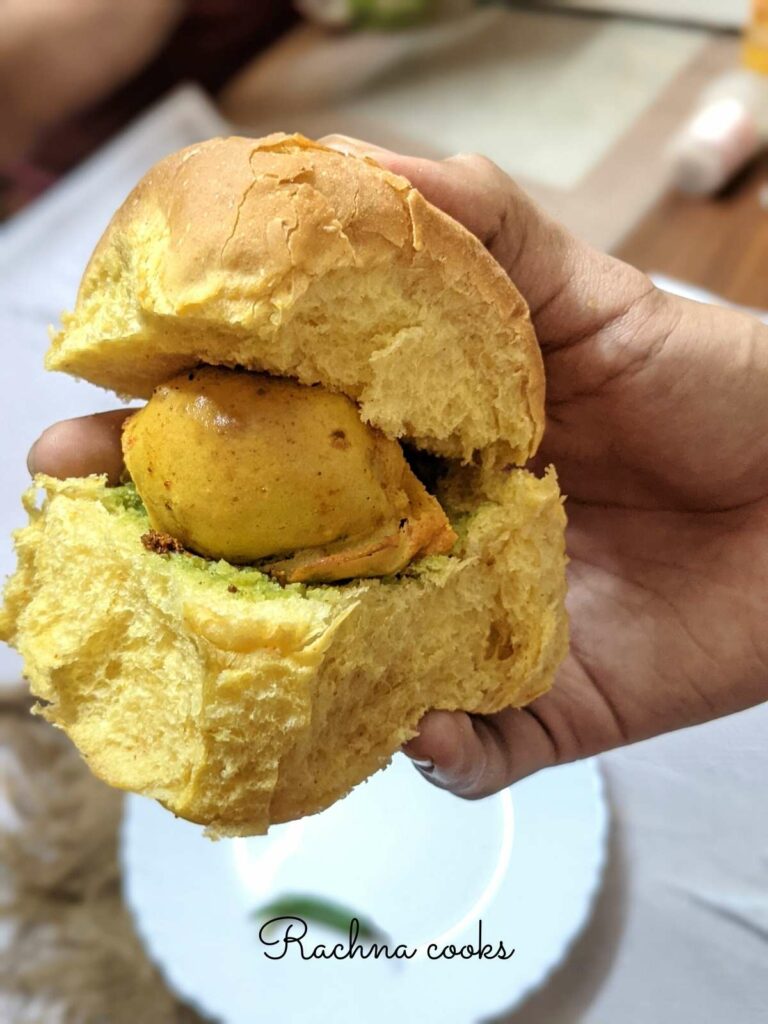 Close up of vada pav held in hand