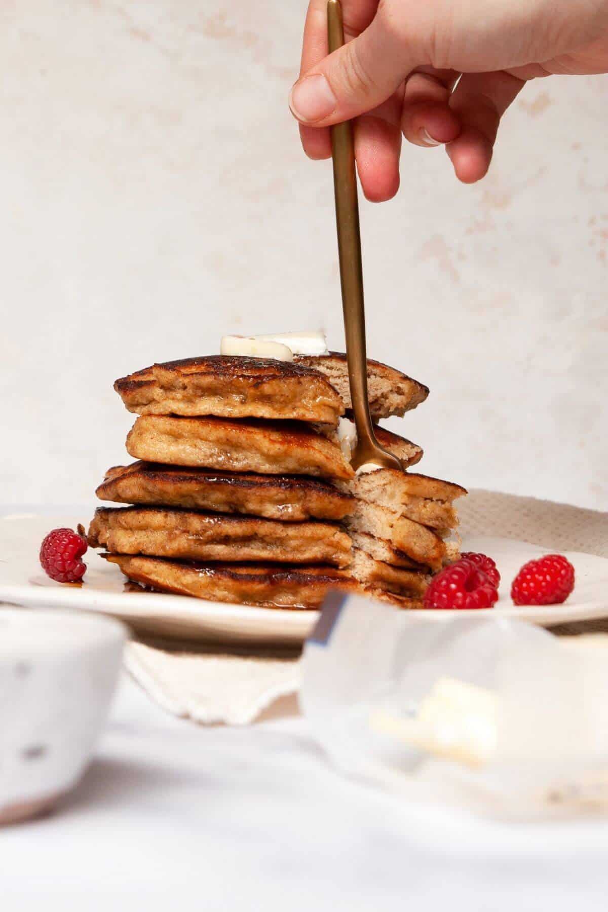 Stack of soft and fluffy almond flour banana pancakes topped with maple syrup.