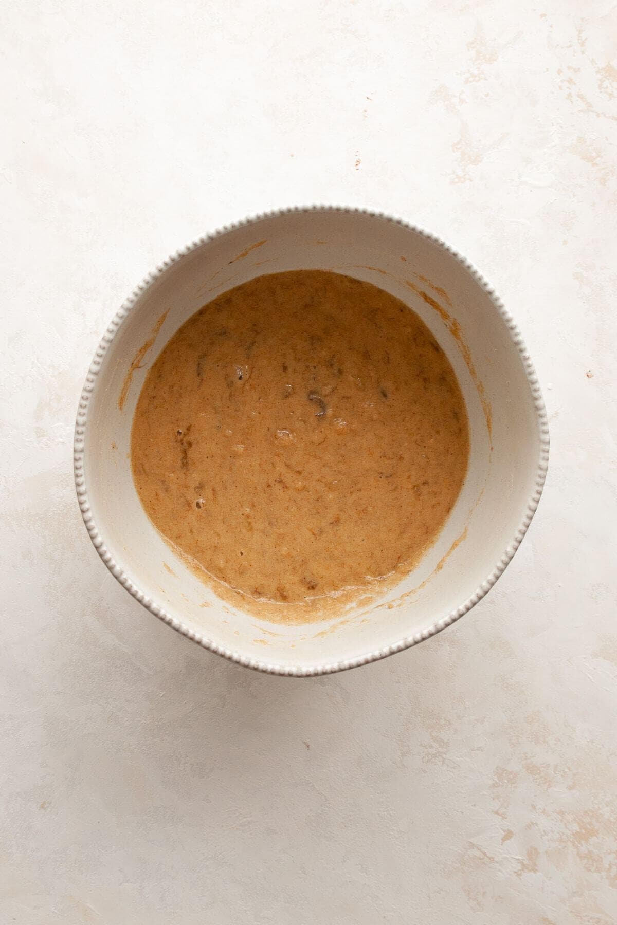 Smooth almond flour banana pancake batter in a mixing bowl, ready to cook.