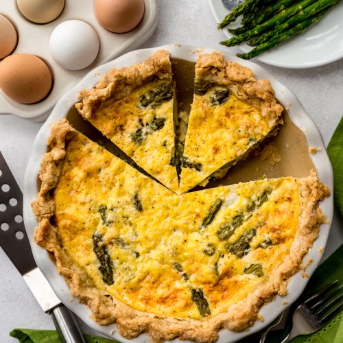 Aerial photo of an asparagus quiche that has been sliced.