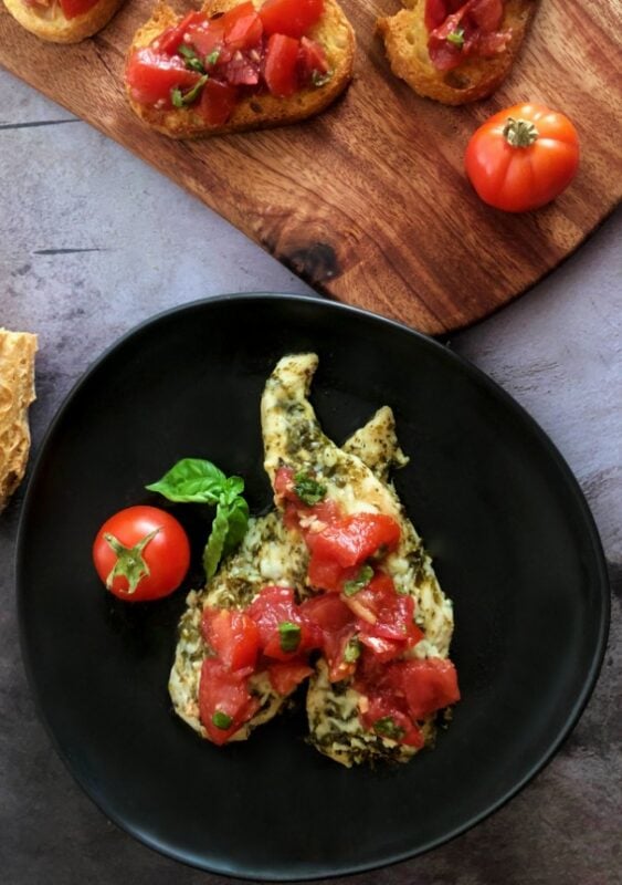baked pesto chicken with bruschetta and bruschetta on bread