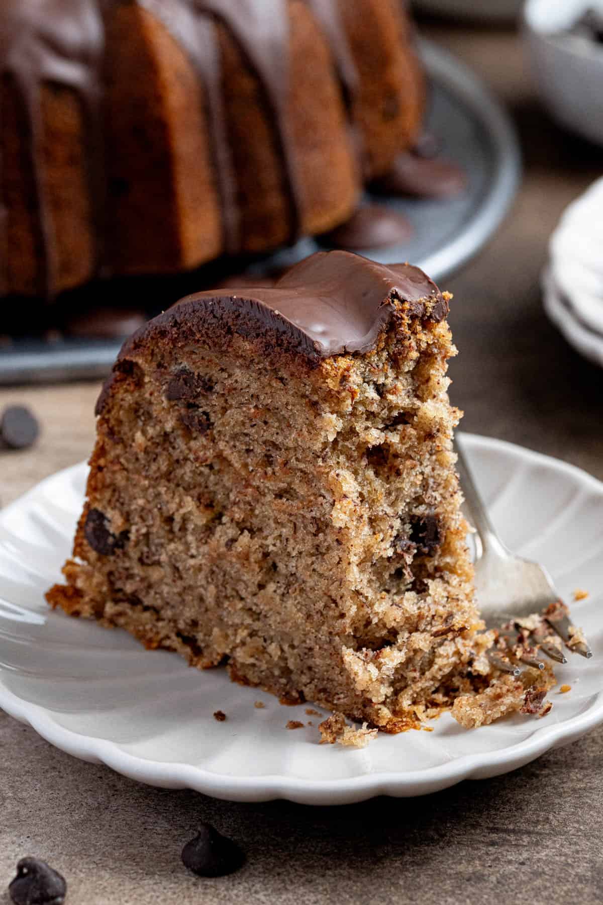 Close up of a slice of vegan banana bundt cake with a forkful removed.