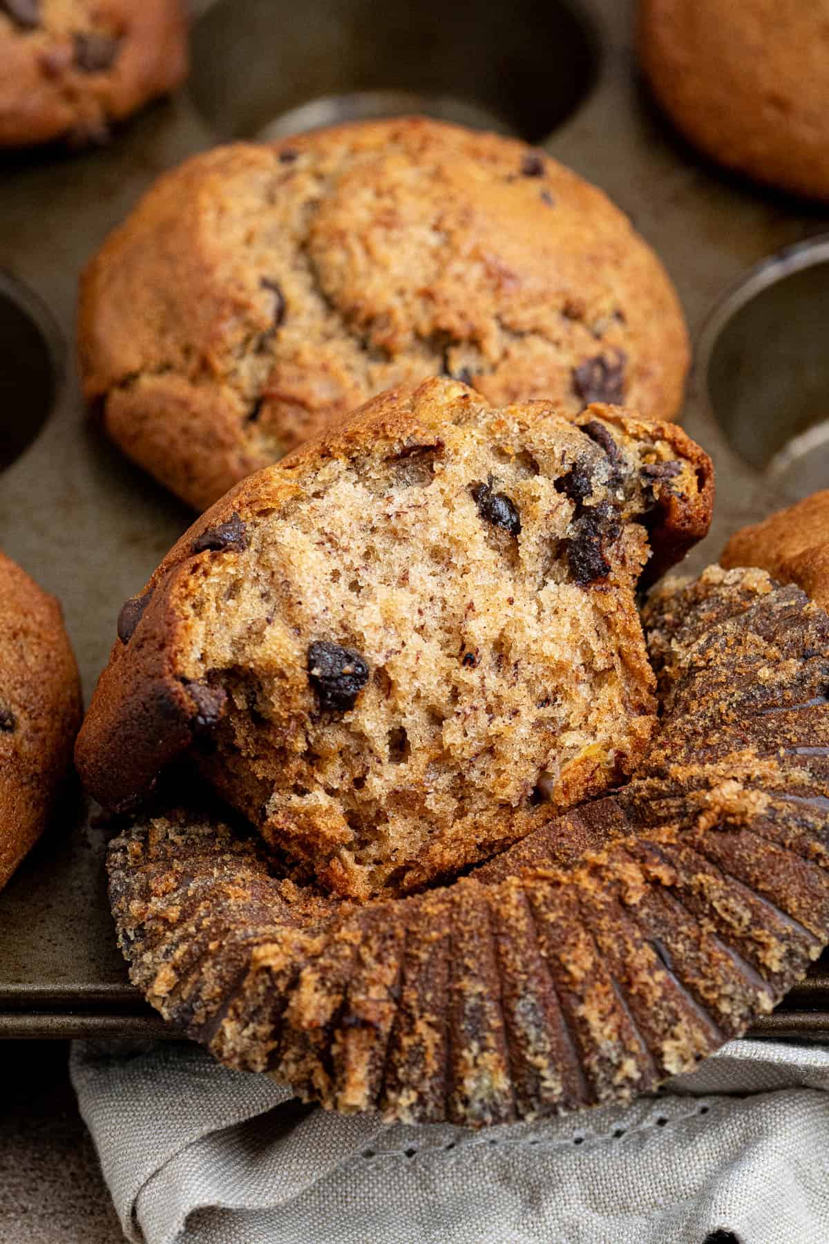 Close up of a vegan banana muffin with a bite taken out of it.