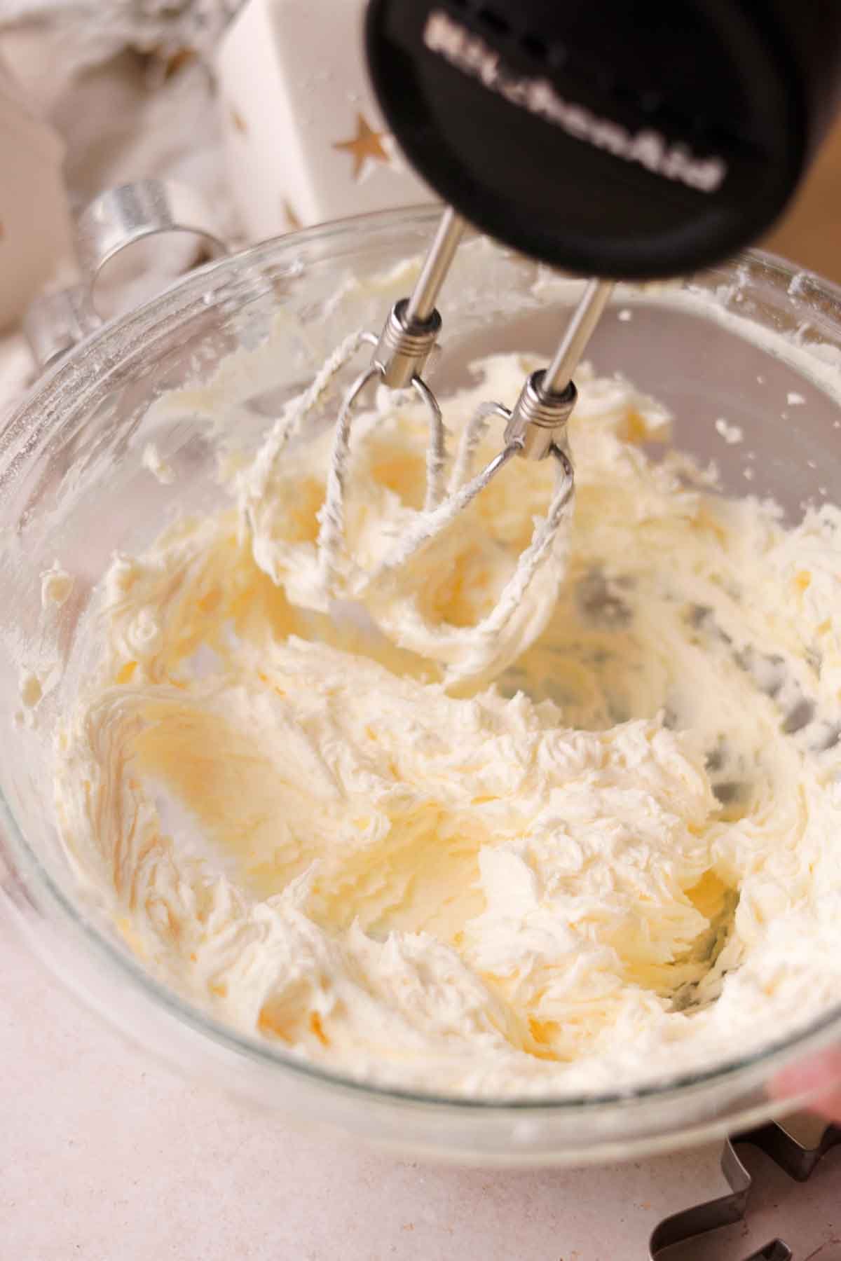 beating butter and sugar together with an electric mixer for buttercream