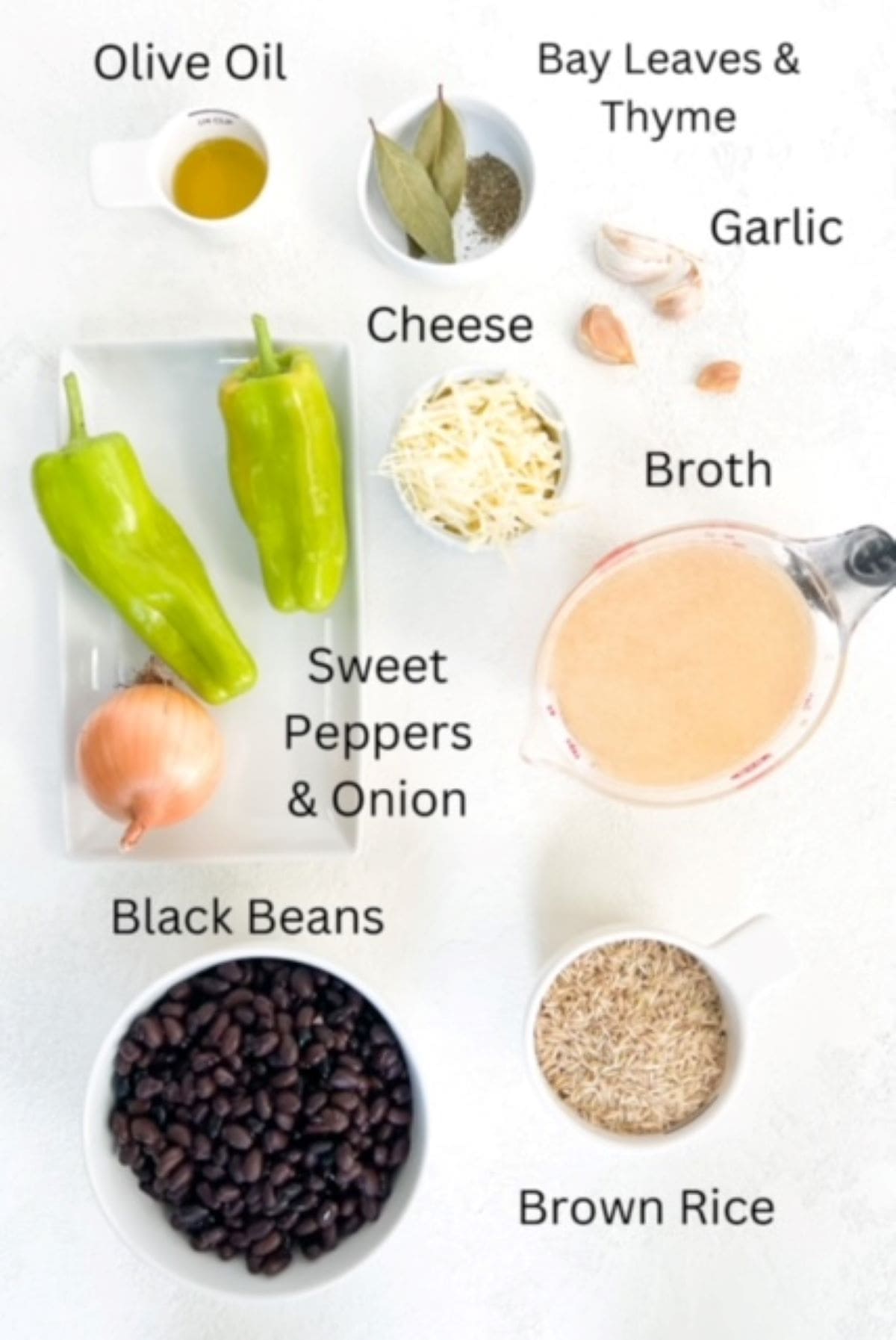 Ingredients to make black beans portioned separately on a white surface and labeled.