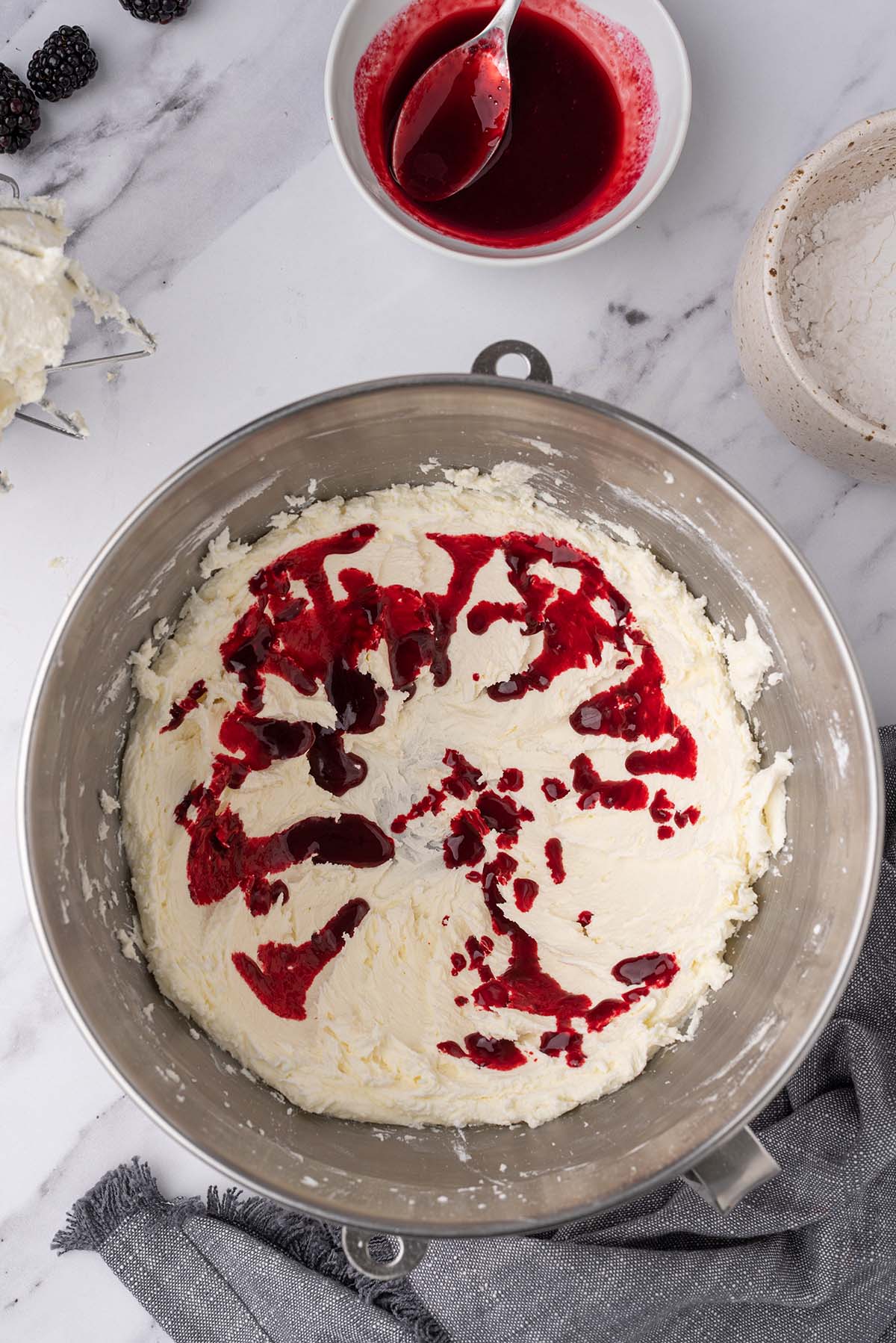 Bowl of mixed butter drizzled with blackberry syrup.