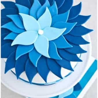 Easy Ombre Cake Decorated With Blue Fondant on Light Gray Background