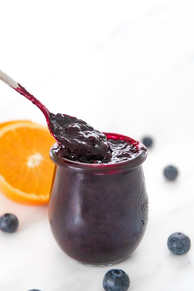 Side photo of a little glass jar of blueberry compote