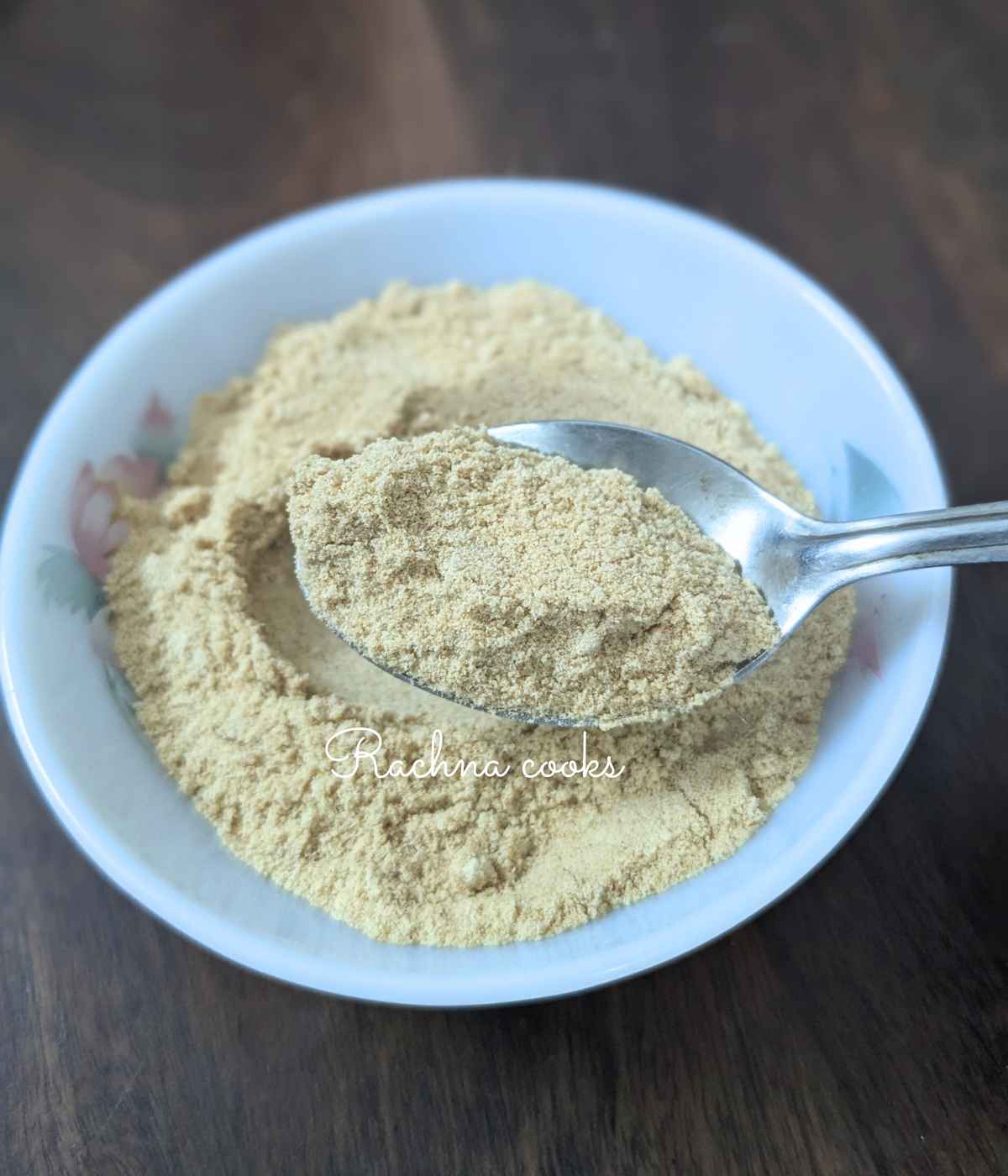 Freshly prepared breadcrumbs in a bowl held up in a spoon