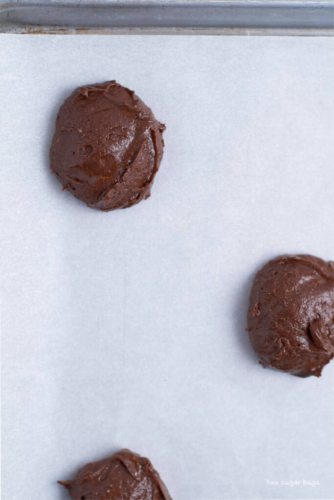 soft brownie cookie dough on parchment lined baking sheet
