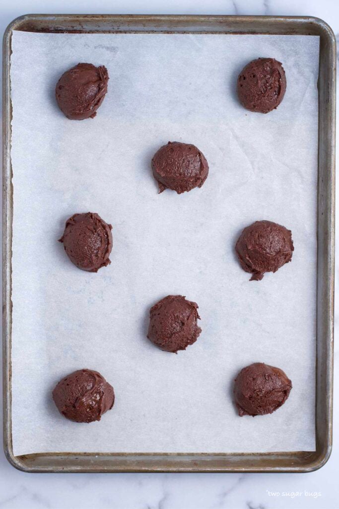 brownie batter cookie dough on baking sheet showing spacing