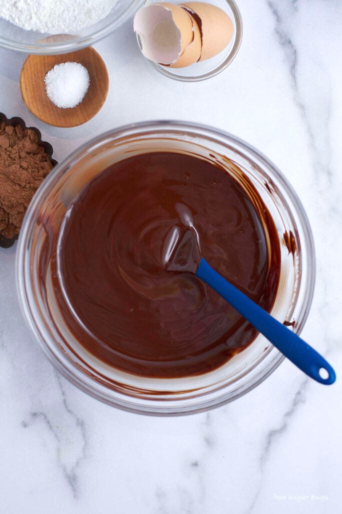 melted butter and chocolate in a bowl with a spatula