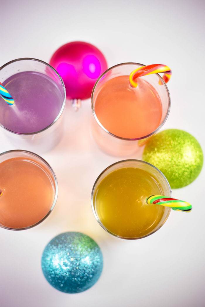 glasses full of colorful candy cane punch on white table