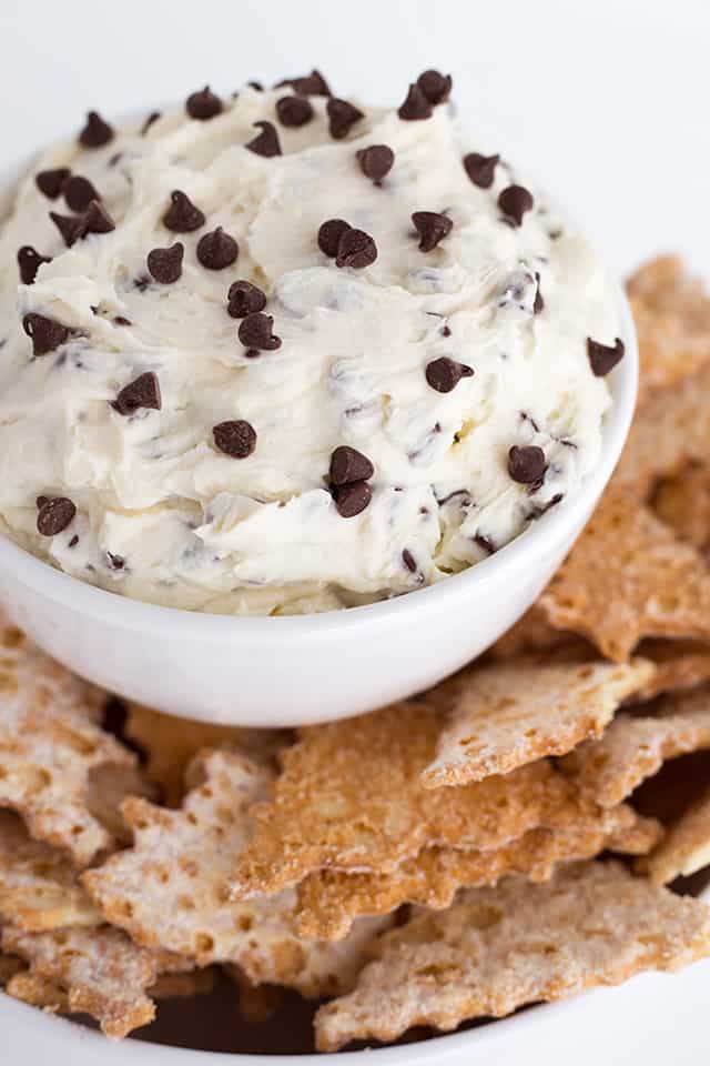 Easy Cannoli Dip Recipe - This Cannoli Dip is such a unique dessert dip. It tastes just like cannoli filling with mascarpone cheese, mini semi-sweet chocolate chip, and ricotta. This thick, sweet dip can be served up with cannoli chips or waffle cone pieces dusted with powdered sugar. #cookiedoughandovenmitt #cannoli #dips #dessert #dessertrecipes #sweets #dessertfoodrecipes #dessertrecipes #partyfood #datenight #appetizers