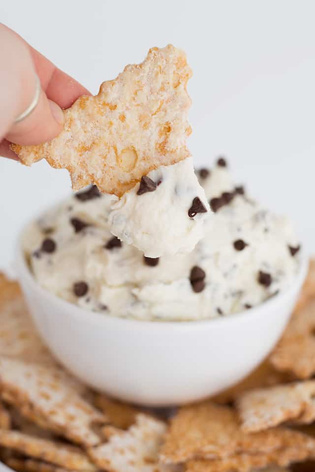 Easy Cannoli Dip Recipe - This Cannoli Dip is such a unique dessert dip. It tastes just like cannoli filling with mascarpone cheese, mini semi-sweet chocolate chip, and ricotta. This thick, sweet dip can be served up with cannoli chips or waffle cone pieces dusted with powdered sugar. #cookiedoughandovenmitt #cannoli #dips #dessert #dessertrecipes #sweets #dessertfoodrecipes #dessertrecipes #partyfood #datenight #appetizers