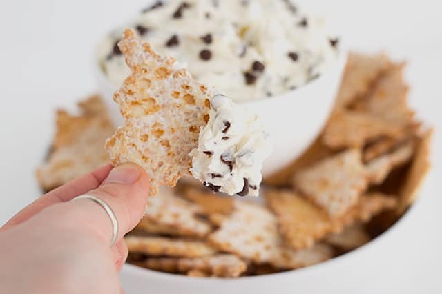 Easy Cannoli Dip Recipe - This Cannoli Dip is such a unique dessert dip. It tastes just like cannoli filling with mascarpone cheese, mini semi-sweet chocolate chip, and ricotta. This thick, sweet dip can be served up with cannoli chips or waffle cone pieces dusted with powdered sugar. #cookiedoughandovenmitt #cannoli #dips #dessert #dessertrecipes #sweets #dessertfoodrecipes #dessertrecipes #partyfood #datenight #appetizers