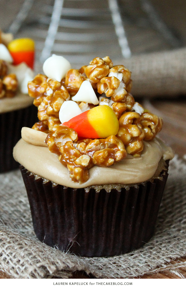 Caramel Corn Cupcakes for Halloween - caramel cupcakes topped with caramel frosting and caramel popcorn studded with candy corn and cashews | by Lauren Kapeluck for TheCakeBlog.com