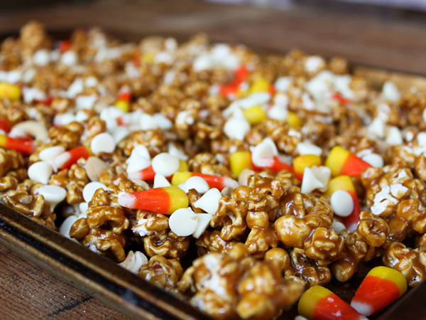 Caramel Corn Cupcakes for Halloween - caramel cupcakes topped with caramel frosting and caramel popcorn studded with candy corn and cashews | by Lauren Kapeluck for TheCakeBlog.com