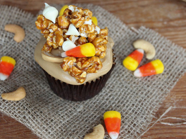 Caramel Corn Cupcakes for Halloween - caramel cupcakes topped with caramel frosting and caramel popcorn studded with candy corn and cashews | by Lauren Kapeluck for TheCakeBlog.com
