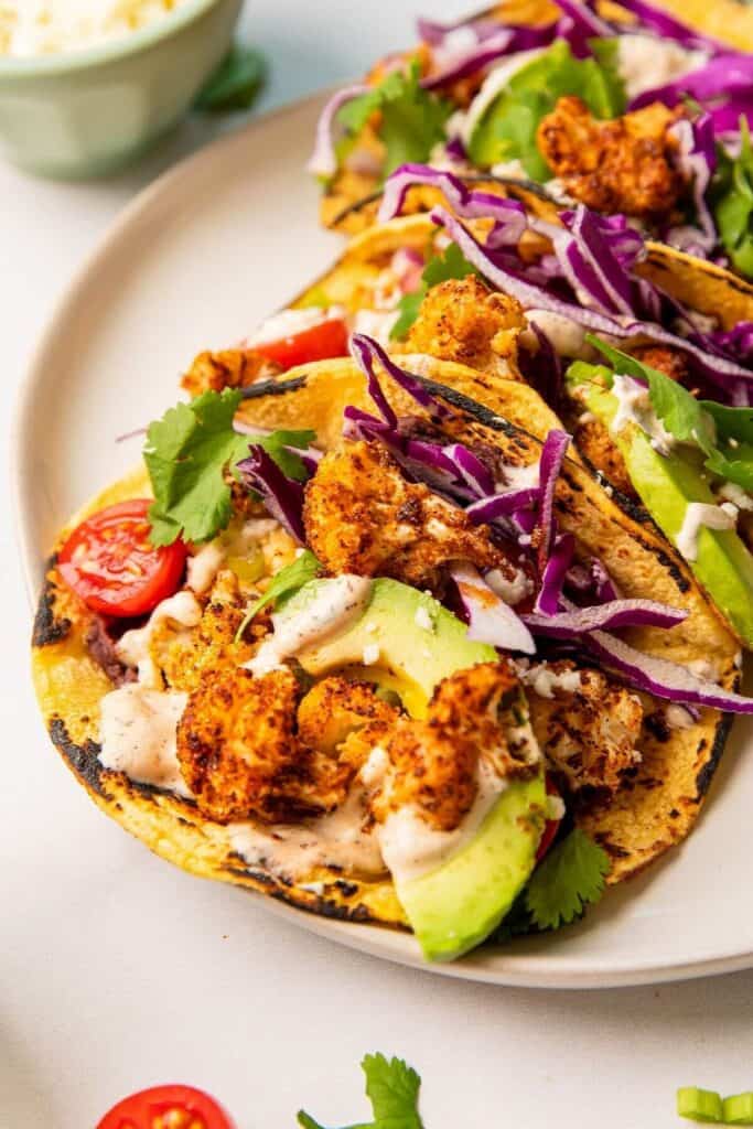 roasted cauliflower taco with crema, avocado, and black beans