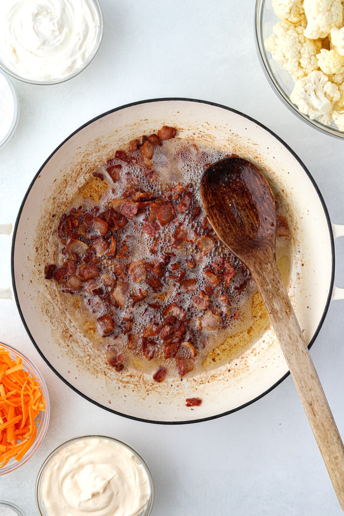 Cooked and crisp bacon in an enameled skillet.