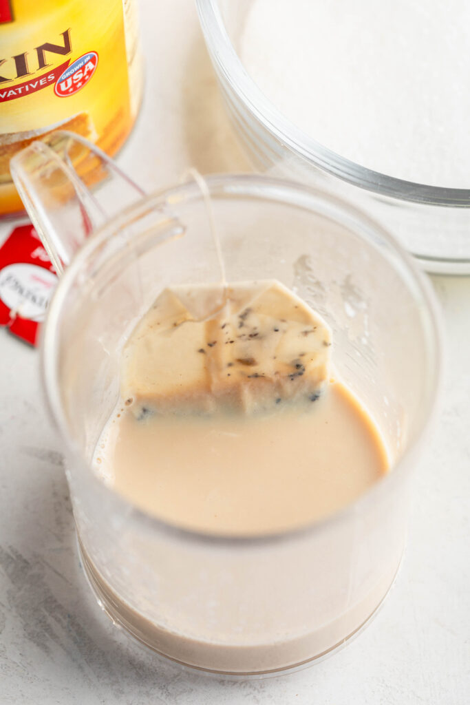 chai tea bag steeping in warm milk