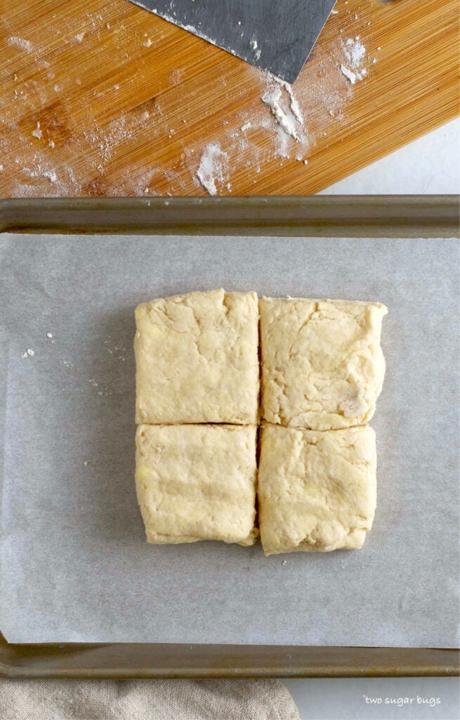 unbaked biscuits on parchment lined baking pan