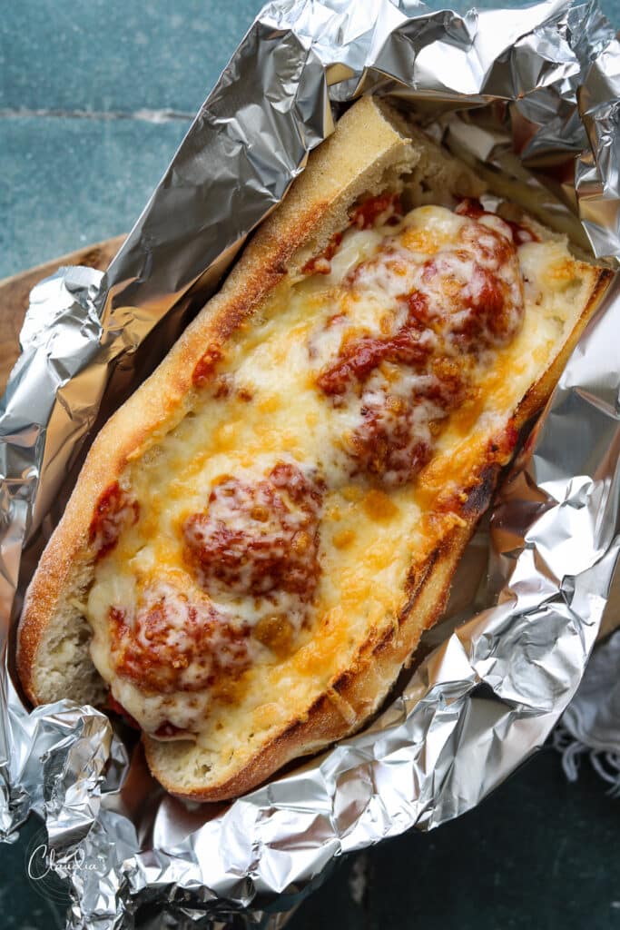 Baked Chicken Pesto Meatball Sub with tons of melted cheese