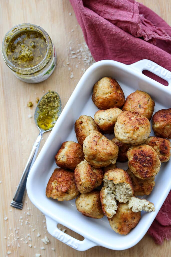 chicken pesto meatballs top view with pesto and napkin