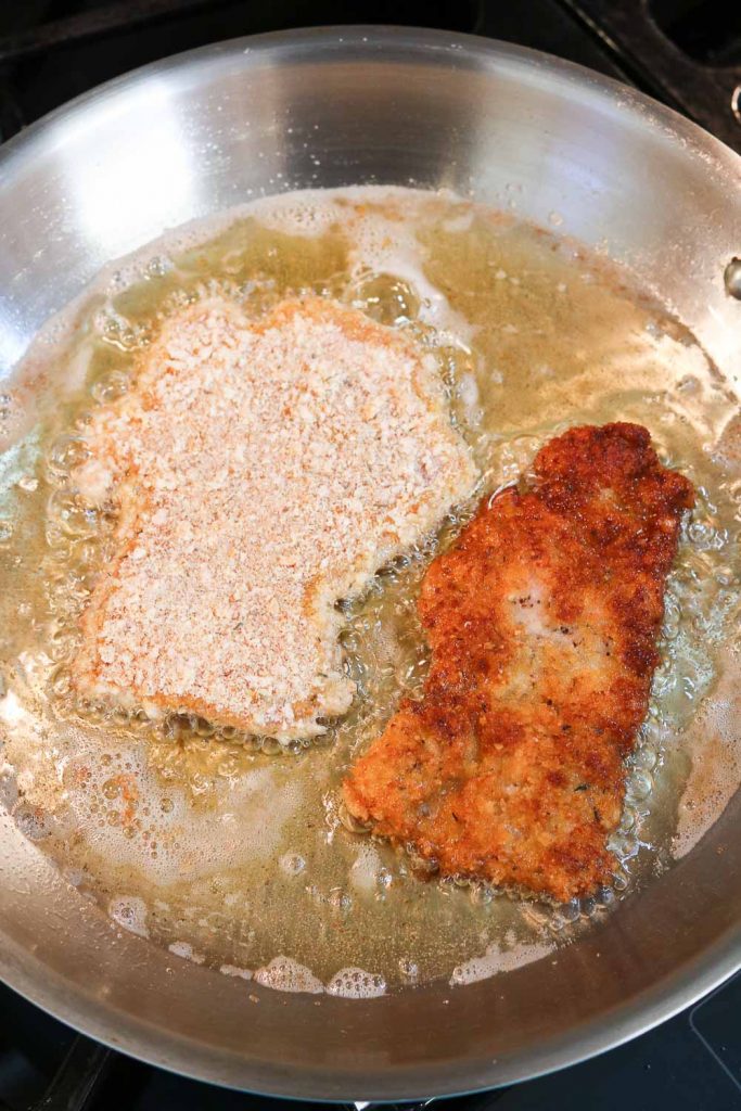Chicken Schnitzel frying in pan 