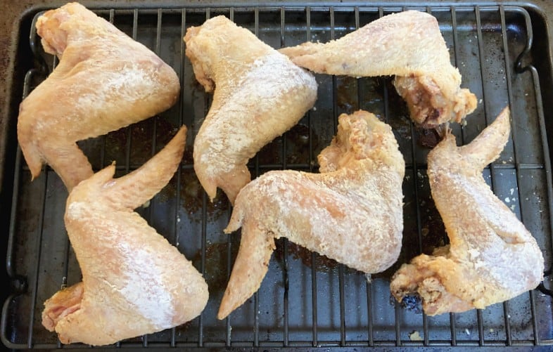 chicken wings coated in baking powder after baking.
