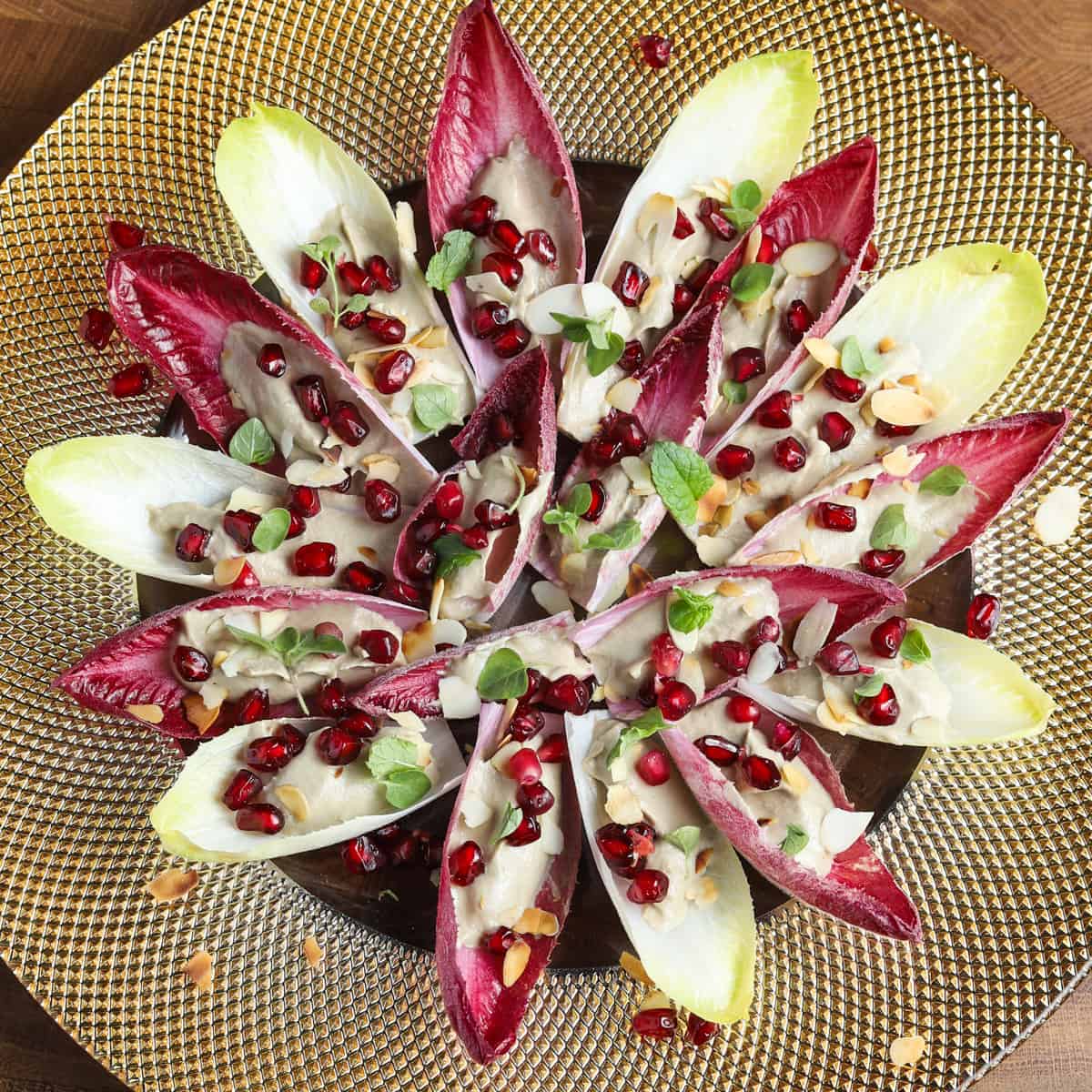 Photo of vegan and gluten-free chicory canapés on a gold plate.