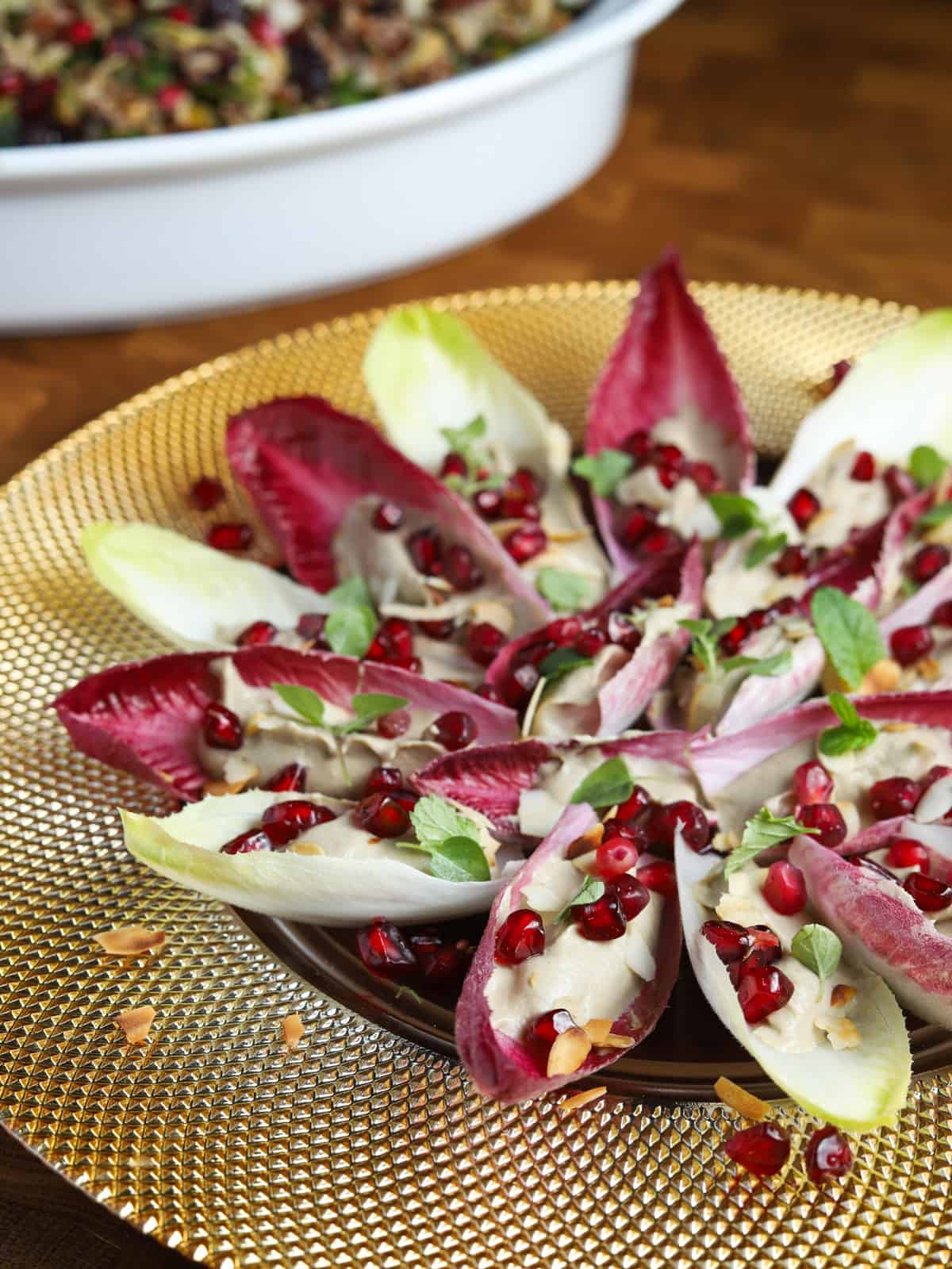 Close-up photo of a gold plate of chicory canapés.