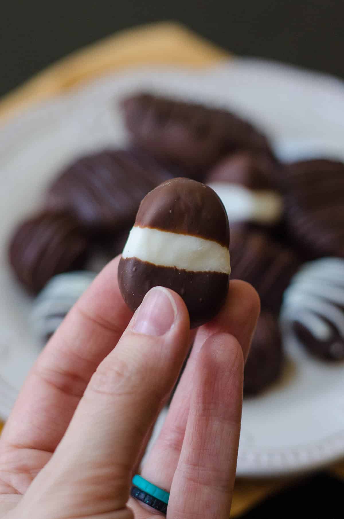 hand holding an easter egg buttercream dipped in chocolate