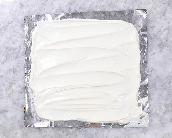 Chocolate Lollipop Ghosts - how to make edible lollipop ghosts for Halloween cakes and cupcakes using white chocolate and suckers | by Erin Gardner for TheCakeBlog.com