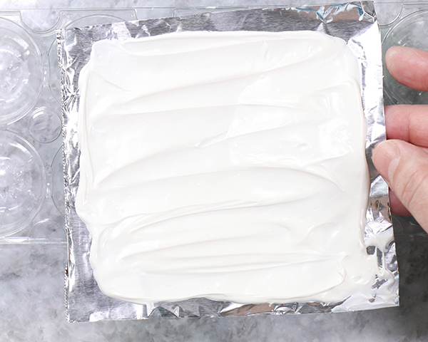 Chocolate Lollipop Ghosts - how to make edible lollipop ghosts for Halloween cakes and cupcakes using white chocolate and suckers | by Erin Gardner for TheCakeBlog.com