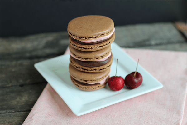 chocolate macaron recipe: chocolate macarons filled with cherry frosting and chocolate ganache