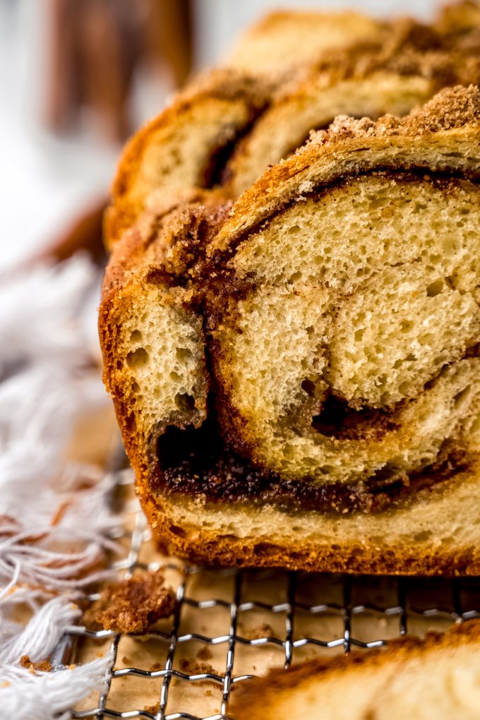 A closeup of cinnamon babka on a wire rack.