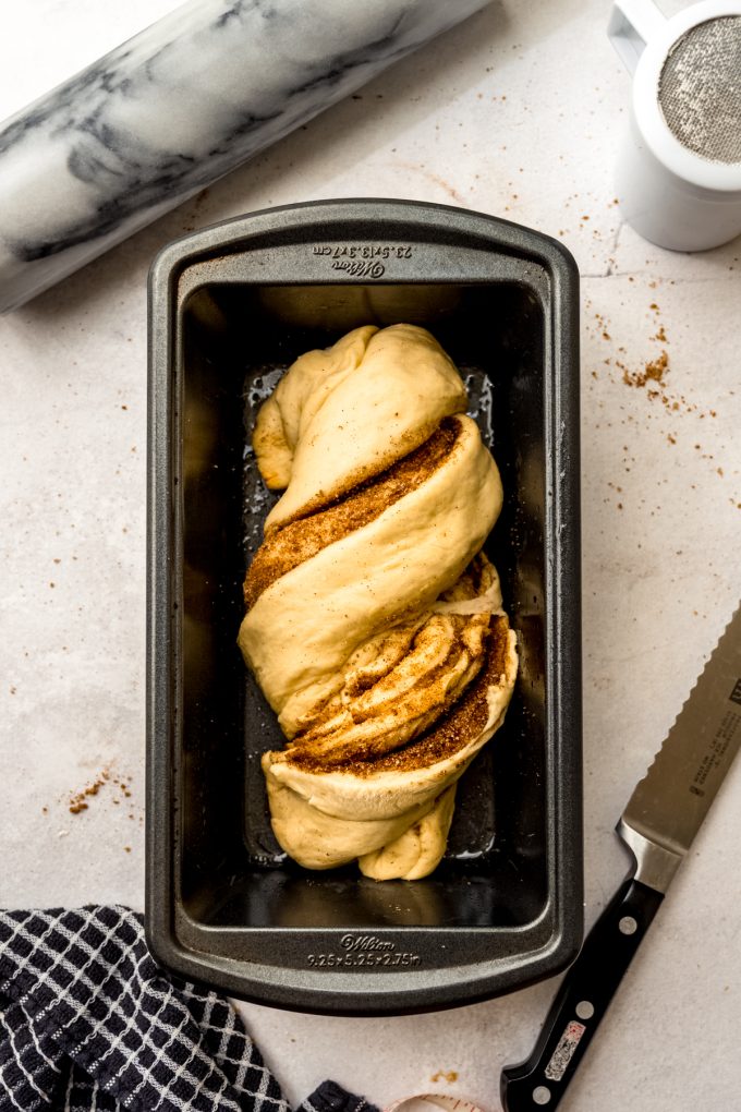 Aerial photo of cinnamon babka dough in a loaf pan after rising.